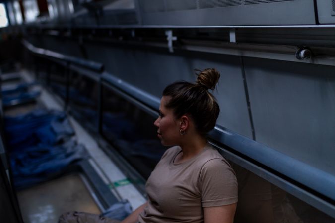 Female soldier on floor of military vehicle