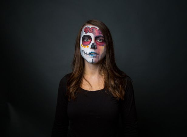 Young woman with creepy face paint