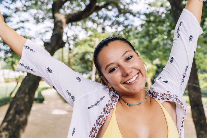 Happy woman stretching arms and smiling