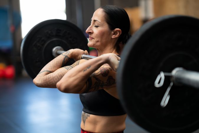 Woman holding heavy barbell