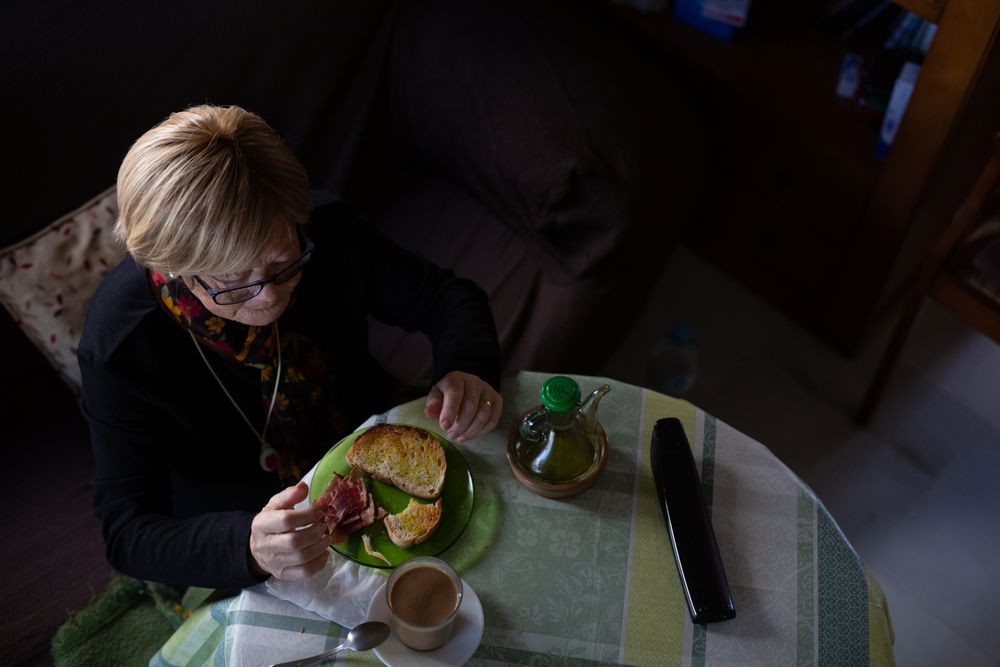 Older woman drinking coffee at breakfast
