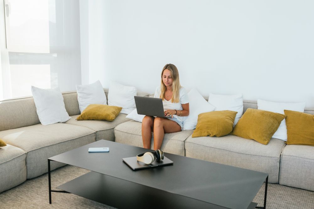 Woman browsing laptop on couch