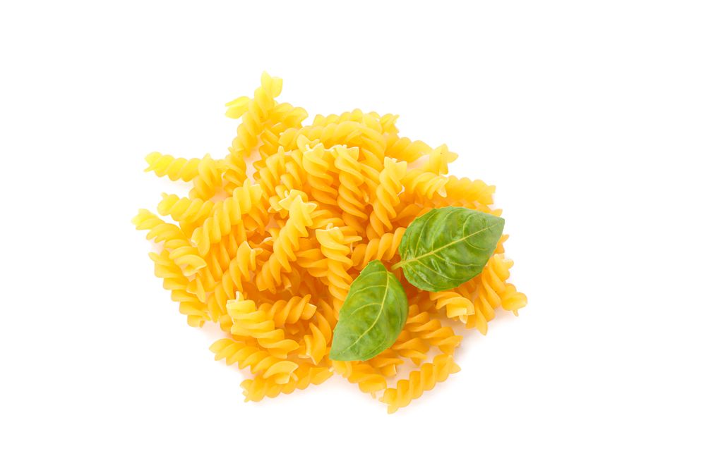 Pasta isolated on light background, top view. Dry uncooked whole pasta