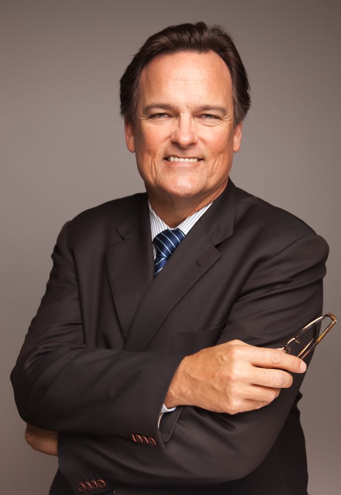 Professional Portrait of Smiling Businessman on Grey Background