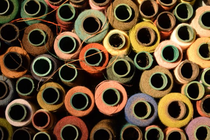 Different colored spools of string for sewing machine
