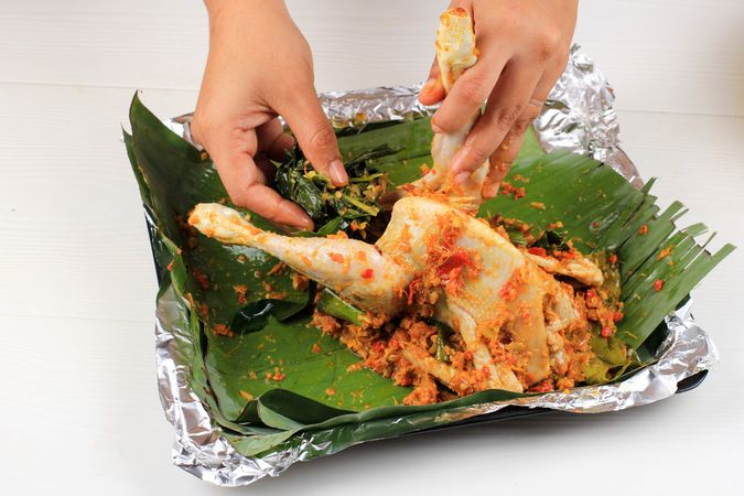 Ayam Betutu, Balinese Roast Chicken Stuffed with Cassava Leaves.