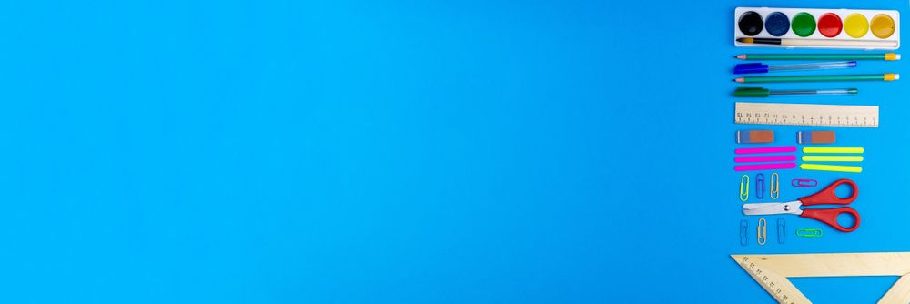 School utensils on blue background