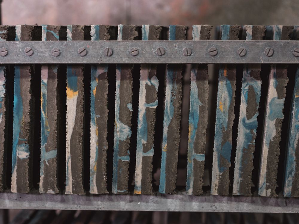 Row of ornamental tiles on shelf