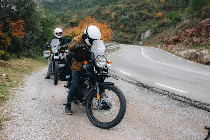 Motorcycle riders pulling over to the side of the road