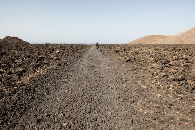 Anonymous traveler on stony road