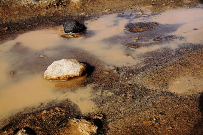 Dirty clay water with rocks