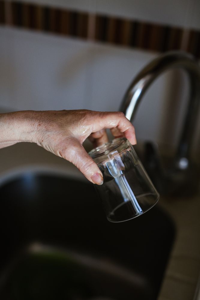 Anonymous mature woman washing dishes
