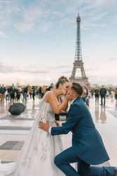 Happy newlyweds in wedding clothing kissing