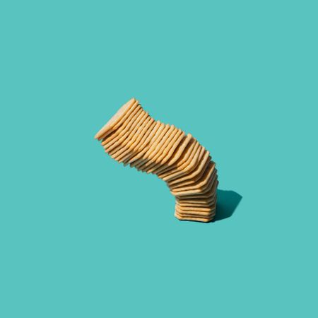 Tower of crackers against a teal background