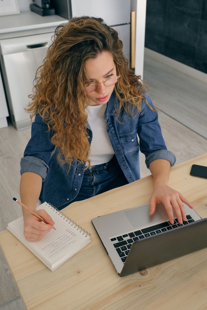 Young businesswoman working on laptop at home