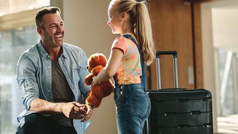 Father and daughter talking after returning from business trip