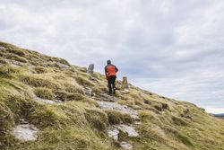 Man walking on hill near valley