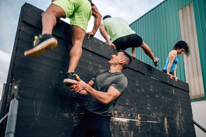 Participants in obstacle course climbing wall