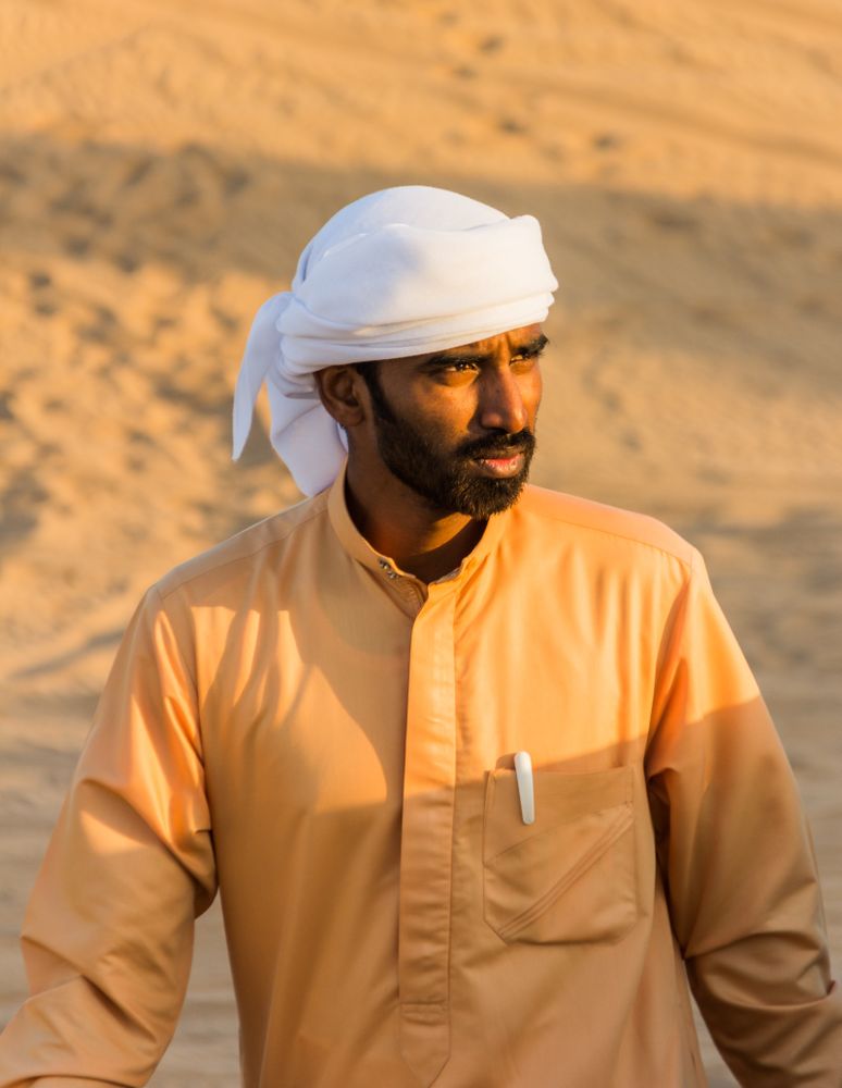 United Arab Emirates - May, 25 2013: Arab man looking away in desert