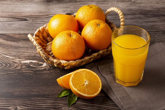 Glass with orange juice on the table.