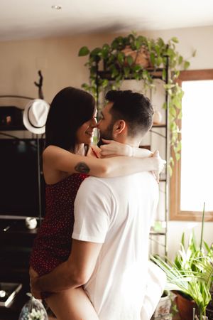 Passionate couple hugging in stylish room