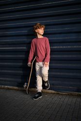 Little skater resting near wall
