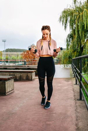 Young woman training with dumbbells
