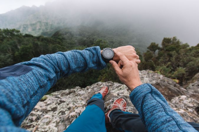 Man's hand with watch in the mountains