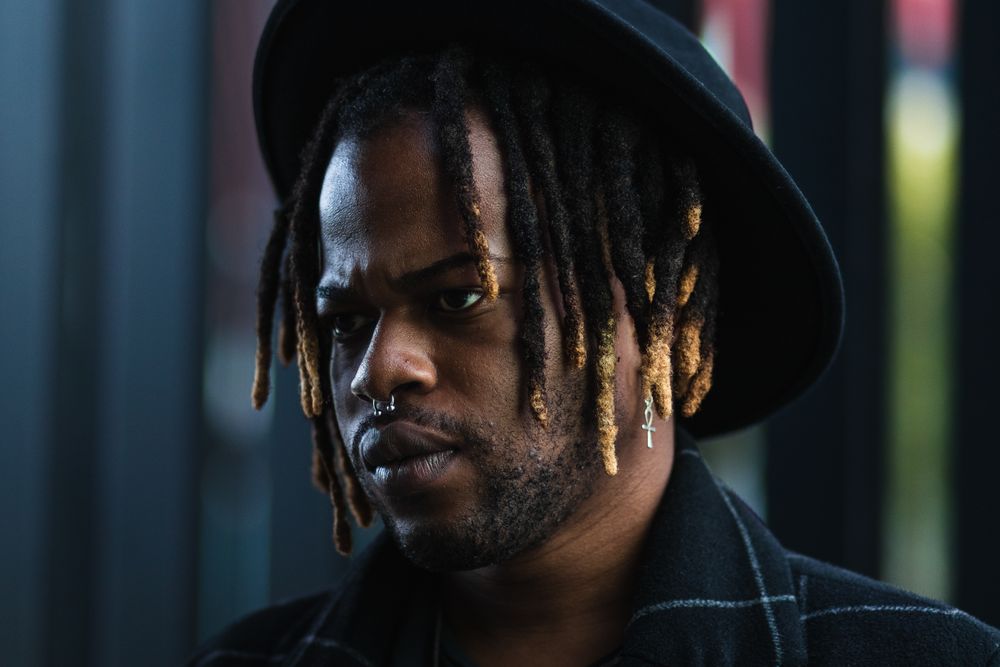 Brutal Black guy in hat on street