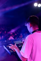 A DJ mixing on stage using board