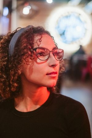 Dreamy woman in glasses looking away