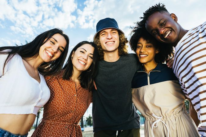 Portrait group of young happy multiracial people standing outdoors in a sunny day