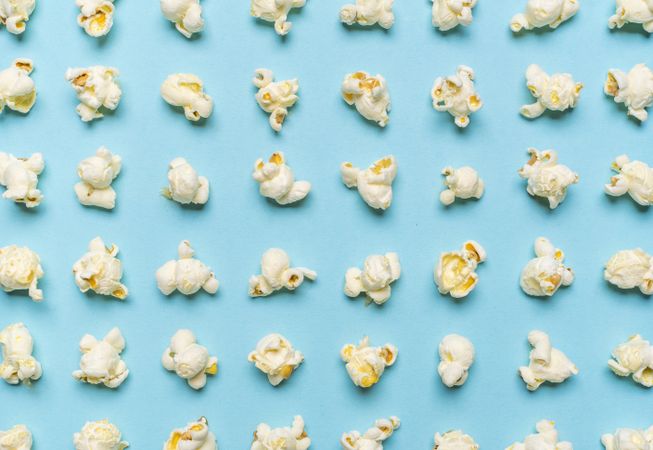 Popcorn flakes aligned on a blue background