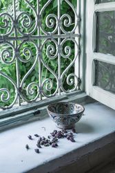 Dried flower buds and bowl near window