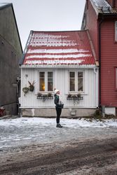 Cheerful female against northern house