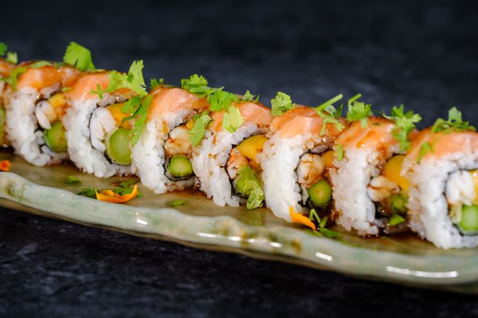 Delicious sushi rolls on traditional marble plate