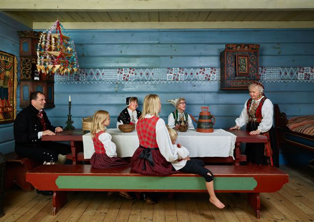 People at dinner table traditional Norwegian clothing gather at Vesterheim, Decorah, Iowa