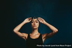 Professional female swimmer on dark background 4d9aLb