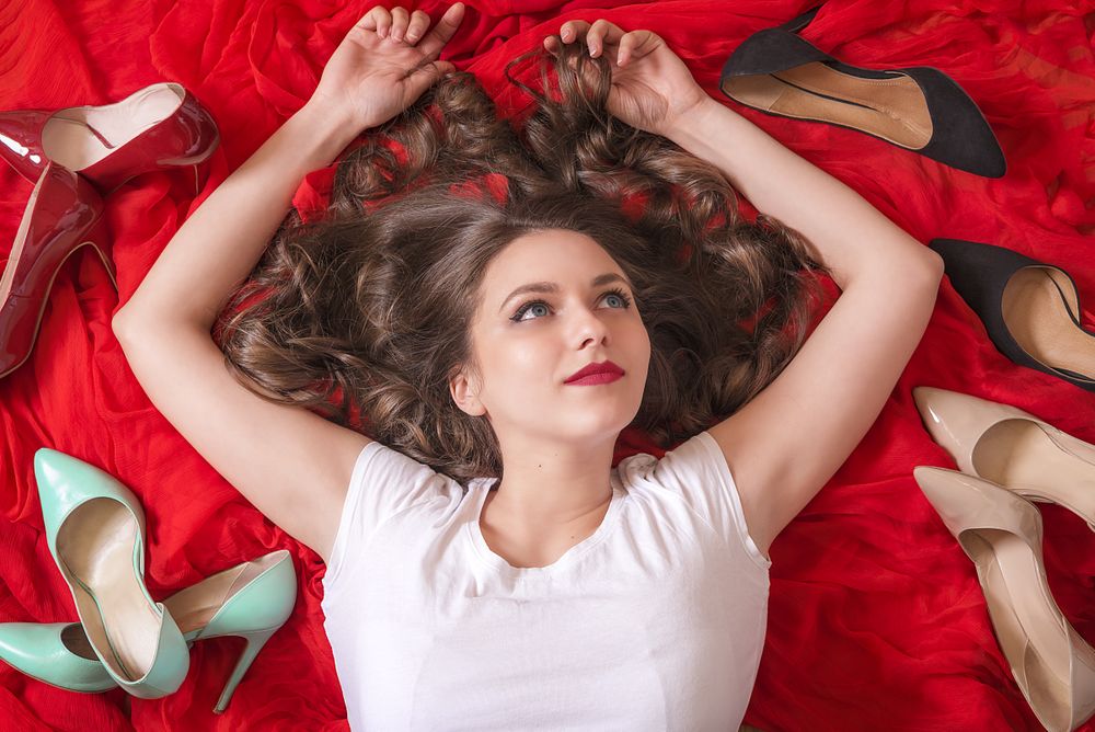 Happy woman with shoes around her