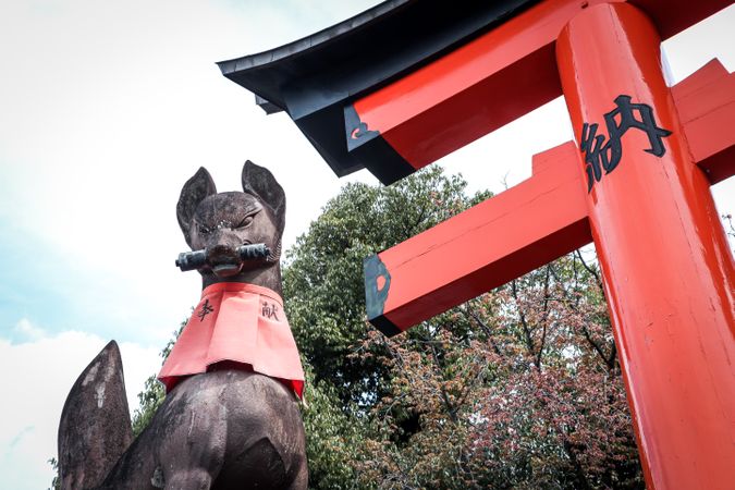 Fox statue at the Fushimi Inari Taisha gate in Japan