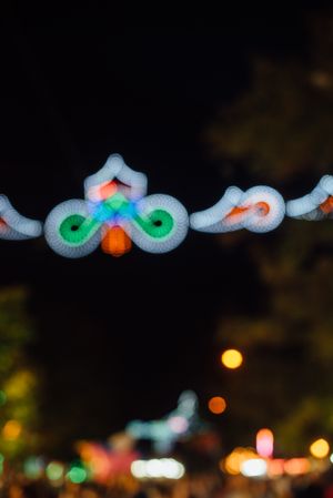 Glowing sign of amusement ride on fairground