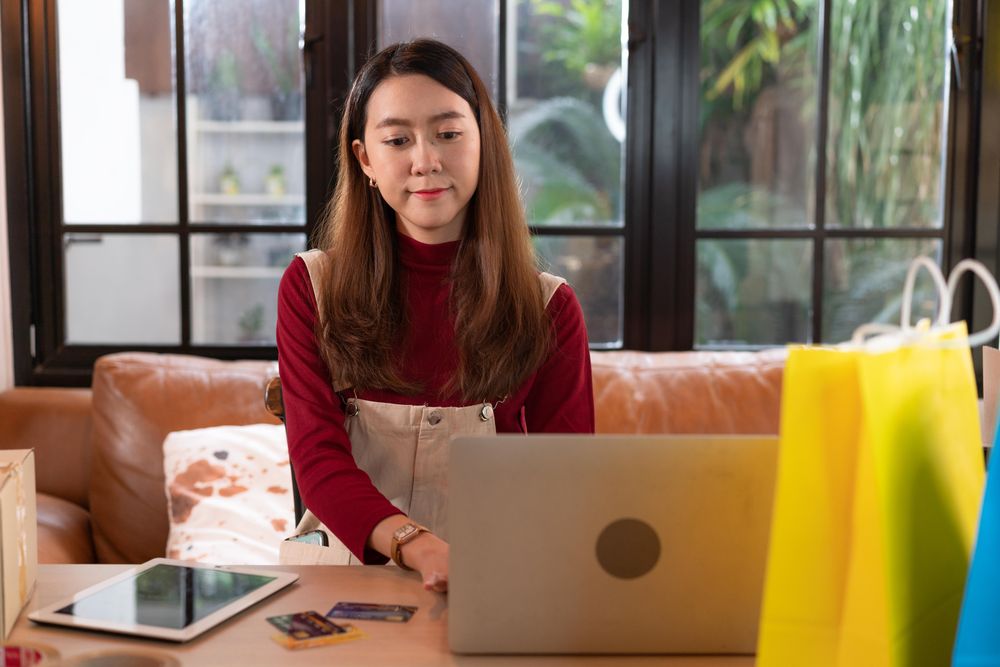 Asian woman working on her shipping business from home