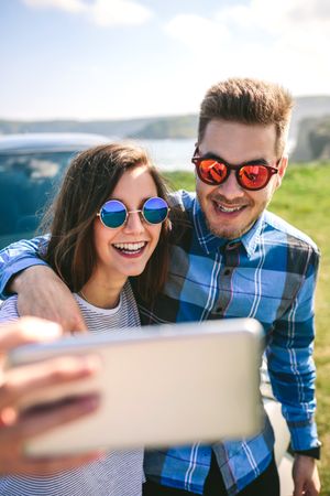 Young couple doing a selfie on the car