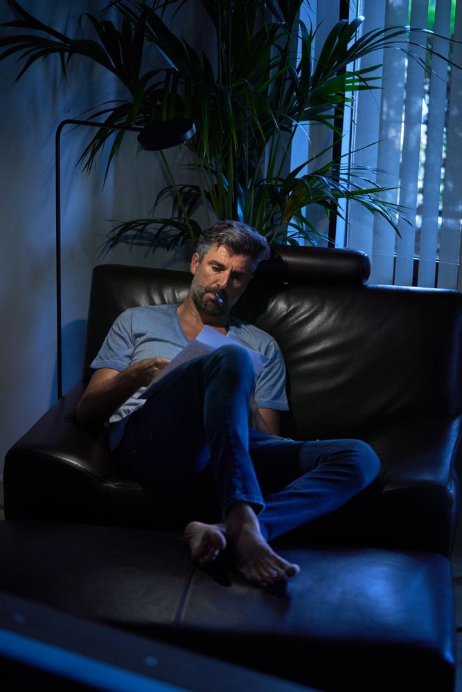 Serious businessman working late in dark office room
