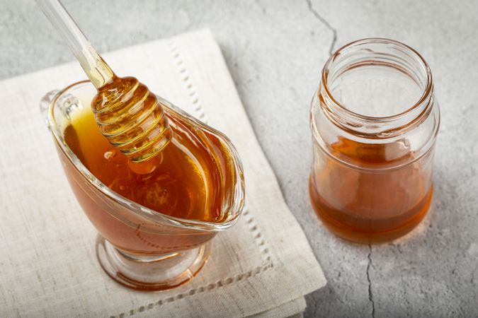 Honey in glass bowl on the table.