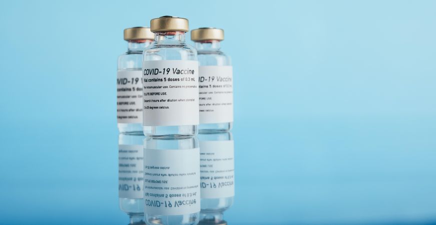 Corona virus prevention vaccine vials on blue background