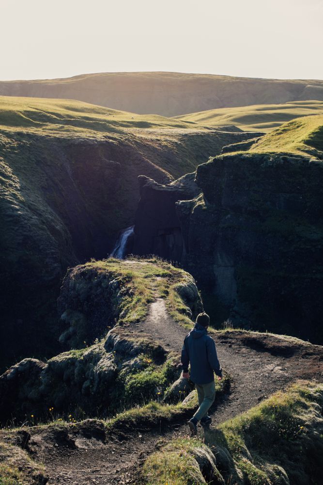 Man walking down trail in nature