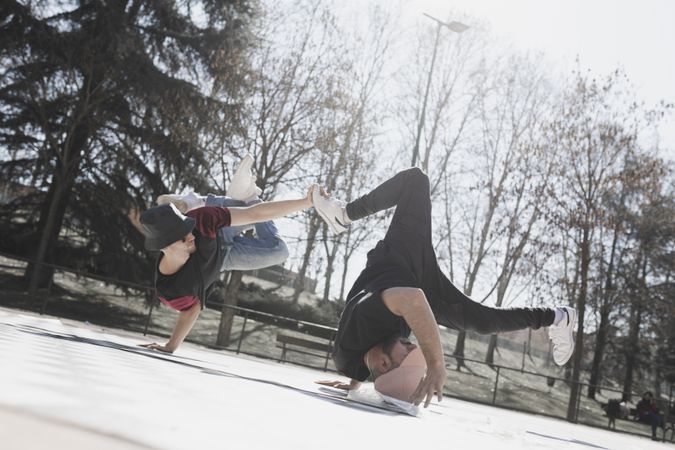 Young men dancing break dance in park