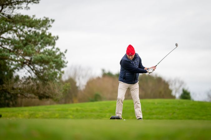 Man swinging on golf course