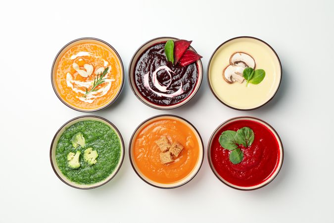 Top view of two rows of different soups
